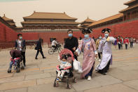 Residents dressed in traditional costumes visit the Forbidden City in Beijing on May 6, 2021. China’s population growth is falling closer to zero as fewer couples have children, the government announced Tuesday, May 11, 2021, adding to strains on an aging society with a shrinking workforce. (AP Photo/Ng Han Guan)