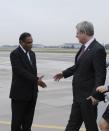 Canada's Prime Minister Stephen Harper (R) is greeted by South Africa's Deputy Minister of International Relations and Cooperation Ebrahim I Ebrahim at Waterkloof Airforce Base in Pretoria December 9, 2013. Harper arrived to attend a memorial service for former South African President Nelson Mandela. South African anti-apartheid hero Mandela died aged 95 at his Johannesburg home on December 5 after a prolonged lung infection. REUTERS/Kopano Tlape/GCIS/Handout via Reuters (SOUTH AFRICA - Tags: POLITICS OBITUARY) ATTENTION EDITORS - THIS IMAGE HAS BEEN SUPPLIED BY A THIRD PARTY. IT IS DISTRIBUTED, EXACTLY AS RECEIVED BY REUTERS, AS A SERVICE TO CLIENTS. FOR EDITORIAL USE ONLY. NOT FOR SALE FOR MARKETING OR ADVERTISING CAMPAIGNS. NO SALES. NO ARCHIVES