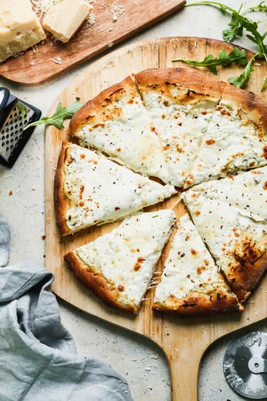 <p>Tastes Better from Scratch</p><p>This delicious white pizza is drizzled with olive oil, garlic and white cheese (no tomato sauce!) culminating in a simple Italian masterpiece!</p><p><strong>Get the recipe: <a href="https://tastesbetterfromscratch.com/white-pizza/" rel="nofollow noopener" target="_blank" data-ylk="slk:White Pizza;elm:context_link;itc:0;sec:content-canvas" class="link ">White Pizza</a></strong></p>