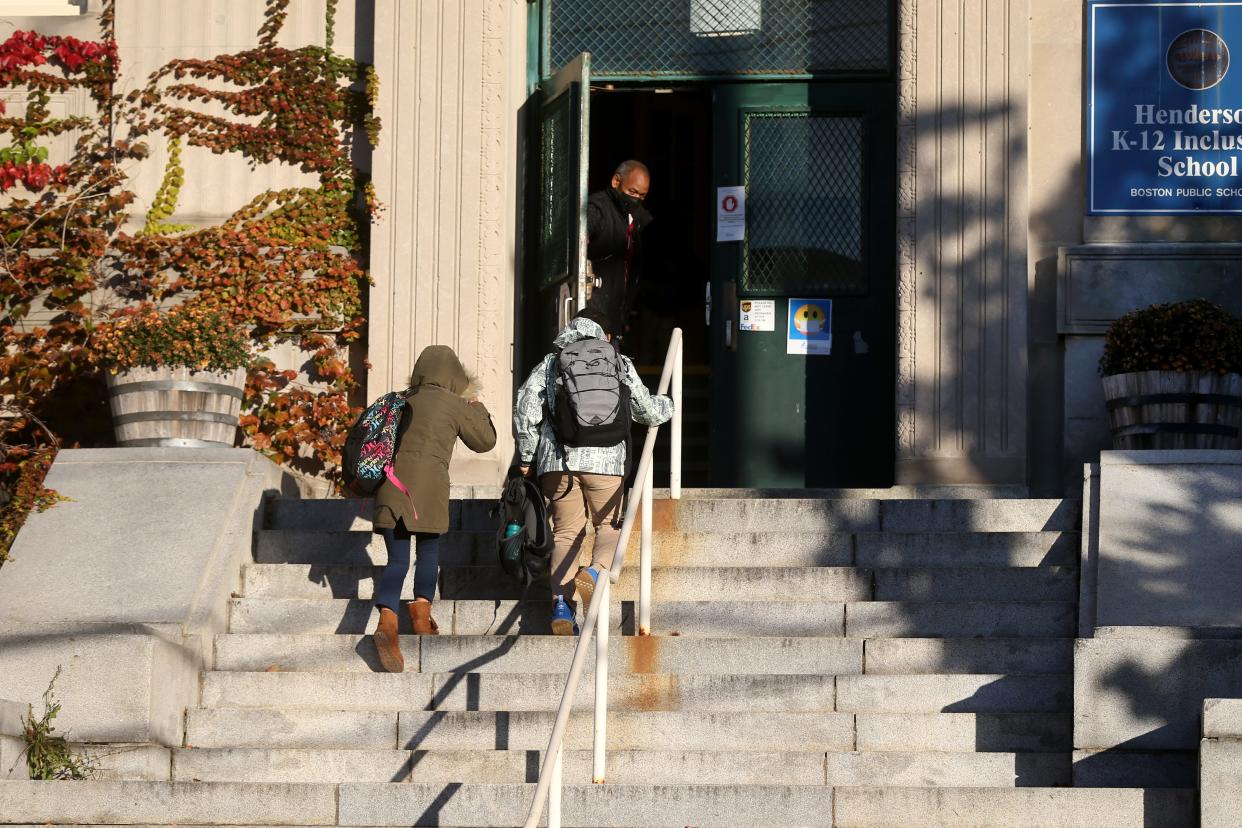 students in front of school steps