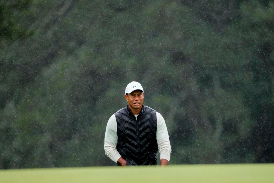 Tiger Woods lines up his putt on the 18th green during the second round of the Masters.