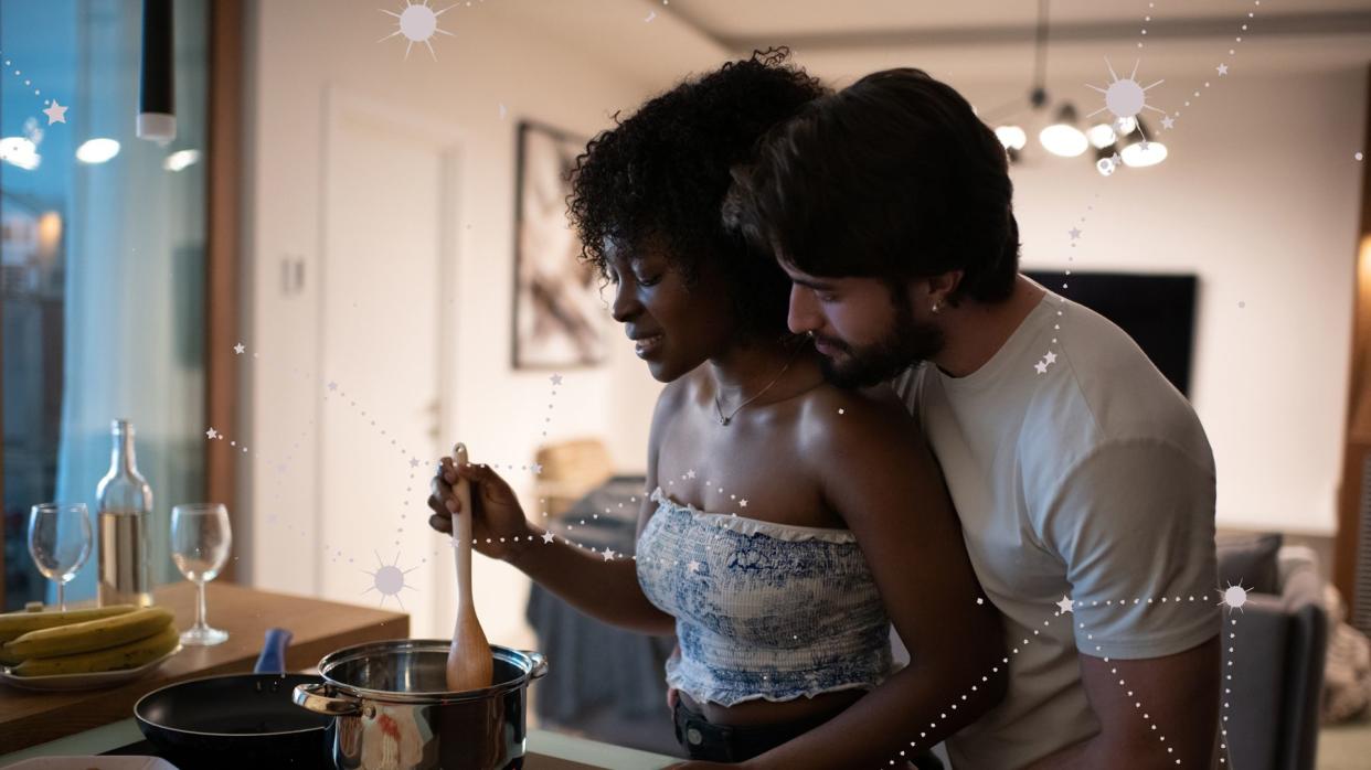 A couple is cooking dinner together on a date.