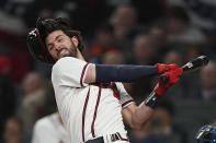 Atlanta Braves' Dansby Swanson loses his helmet on a swing during the third inning in Game 1 of baseball's National League Championship Series against the Los Angeles Dodgers Saturday, Oct. 16, 2021, in Atlanta. (AP Photo/Brynn Anderson)