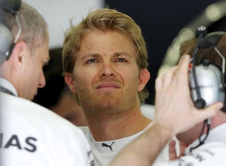 Mercedes Formula One Driver Nico Rosberg of Germany looks at the monitor at the pit-lane during the third free practice ahead of Bahrain's F1 Grand Prix at Bahrain International Circuit, south of Manama April 18, 2015. REUTERS/Ahmed Jadallah