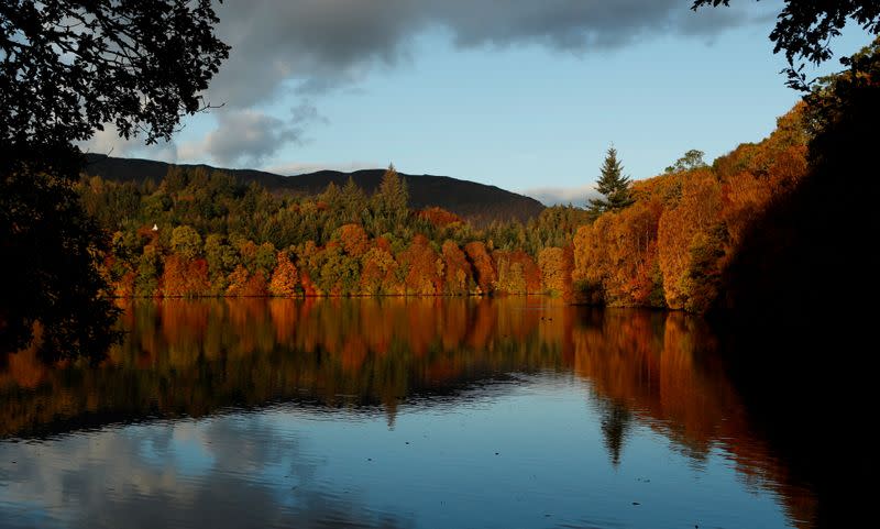 FILE PHOTO: Autumn leaves are reflected on Loch Faskally, Pitlochry, Scotland