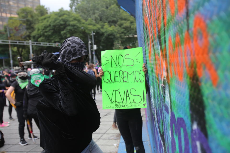 A woman wields a hammer during an abortion-rights demonstrators on the Day for Decriminalization of Abortion, in Mexico City, Tuesday, Sept. 28, 2021. (AP Photo/Ginnette Riquelme)