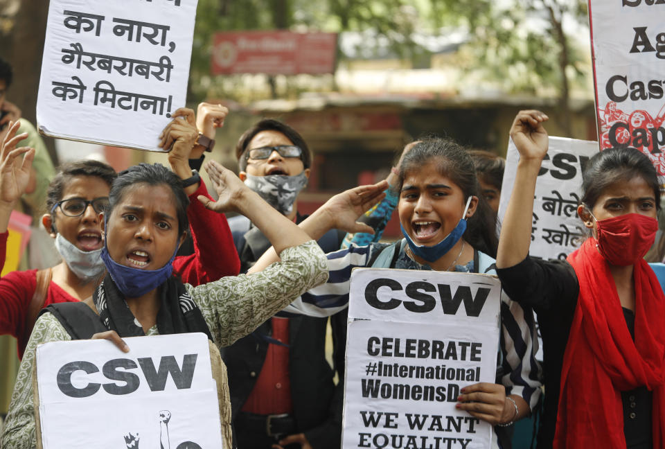 Members of different women non governmental organizations shout slogans to mark International Women's Day in New Delhi, India, Monday, March 8, 2021. Thousands of female farmers have held sit-ins and a hunger strike in India's capital in protests on International Women's Day against new agricultural laws. (AP Photo/Manish Swarup)