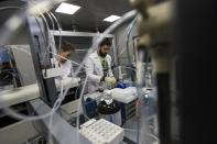 FILE- In this Tuesday, May 24, 2016, file photo employees Natalya Bochkaryova, left, and Ilya Podolsky work at the Russia's national drug-testing laboratory in Moscow, Russia. It was at this laboratory, and its former site elsewhere in Moscow, that lab director Grigory Rodchenkov conducted pioneering research into steroids, at the same time as he says he was giving Russian athletes a "cocktail" of banned substances. (AP Photo/Alexander Zemlianichenko, file)