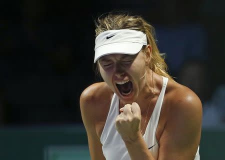 Maria Sharapova of Russia celebrates a point against Agnieszka Radwanska of Poland during their WTA Finals singles tennis match at the Singapore Indoor Stadium October 24, 2014. REUTERS/Edgar Su