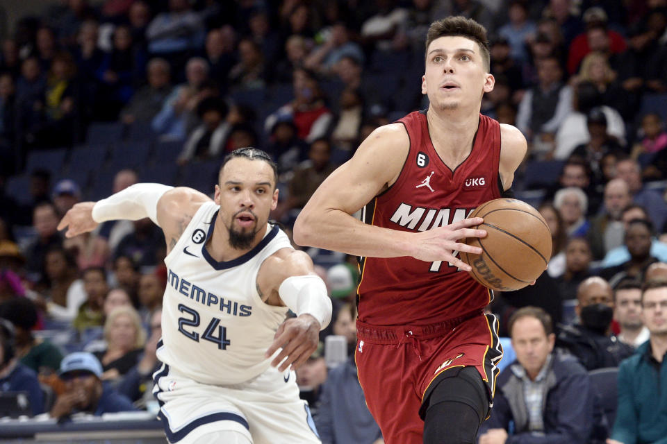 Miami Heat guard Tyler Herro looks to shoot ahead of Memphis Grizzlies forward Dillon Brooks (24) in the second half of an NBA basketball game, Monday, Dec. 5, 2022, in Memphis, Tenn. (AP Photo/Brandon Dill)