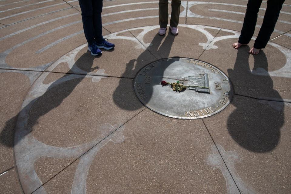 Shadows of three walkers in a labyrinth at Forest Lawn Memorial Park in Glendale