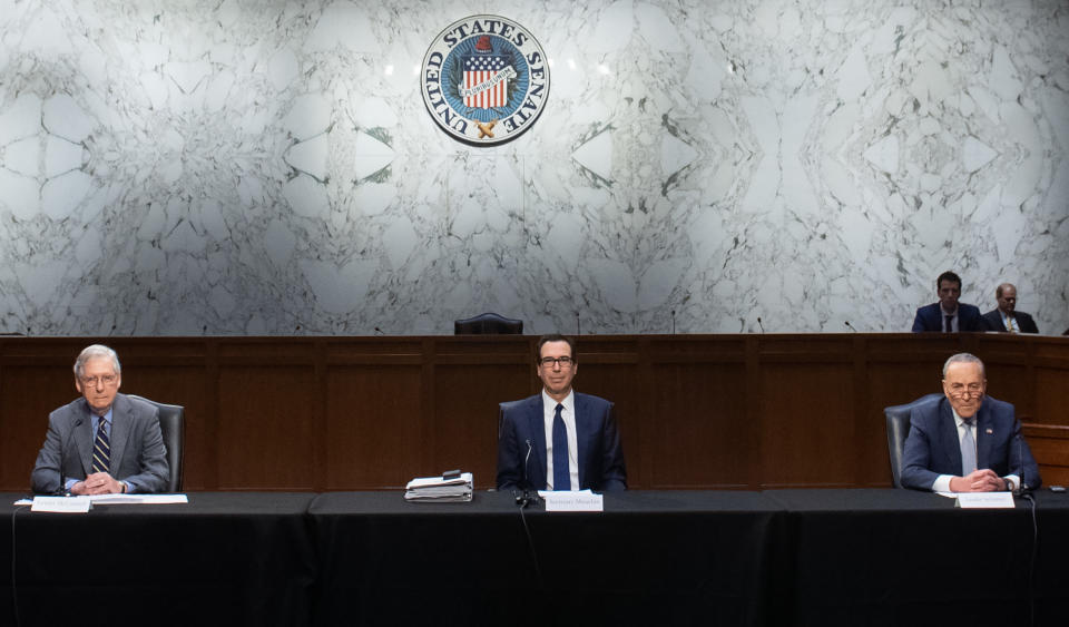 (L-R) Senate Majority Leader Mitch McConnell, Secretary of Treasury Steven Mnuchin, and Senate Minority Leader Chuck Schumer hold a meeting to discuss a potential economic bill in response to the coronavirus, COVID-19, in Washington, DC, on March 20, 2020. - Senate Majority Leader Mitch McConnell unveiled on March 19, an economic rescue plan to send $1,200 direct checks to taxpayers, $300 billion for small businesses to keep idled workers on payroll and $208 billion in loans to airlines and other industries. (Photo by SAUL LOEB / AFP) / The erroneous mention[s] appearing in the metadata of this photo by SAUL LOEB has been modified in AFP systems in the following manner: [2020] instead of [2019]. Please immediately remove the erroneous mention[s] from all your online services and delete it (them) from your servers. If you have been authorized by AFP to distribute it (them) to third parties, please ensure that the same actions are carried out by them. Failure to promptly comply with these instructions will entail liability on your part for any continued or post notification usage. Therefore we thank you very much for all your attention and prompt action. We are sorry for the inconvenience this notification may cause and remain at your disposal for any further information you may require. (Photo by SAUL LOEB/AFP via Getty Images)