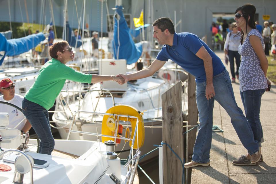 Port Huron City Manager James Freed walks along the Black River with his wife, Jessie, talking with boaters during the Blue Water Fest's Family Night in 2015.