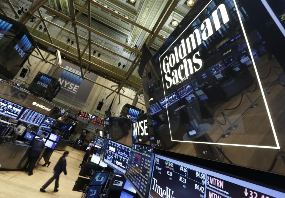 FILE - In this Aug. 15, 2014, file photo, a lighted sign marks the Goldman Sachs trading post on the floor of the New York Stock Exchange. (AP Photo/Richard Drew, File)