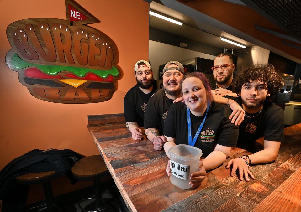 Burger Bah employee Samantha Arglin, with her co-workers, from left, Mateo Furtado-Valle, Drew Day, Khris Perez and Jonathan Bowman. Arglin lost her home recently in a three-decker fire and her coworkers are donating their tips to help her.