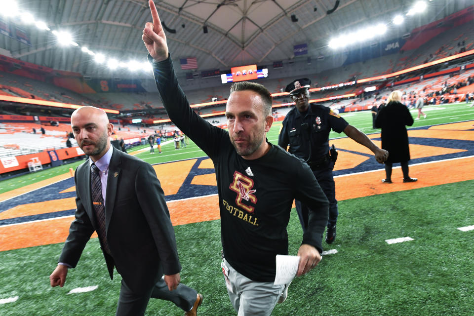Boston College coach Jeff Hafley runs off the field after the team's win against Syracuse in an NCAA college football game in Syracuse, N.Y., Friday, Nov. 3, 2023. (AP Photo/Adrian Kraus)