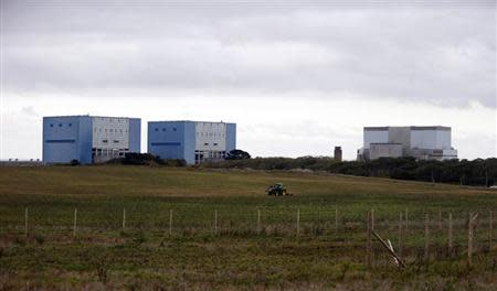 A tractor mows a field on the site where EDF Energy's Hinkley Point C nuclear power station will be constructed in Bridgwater, southwest England in this file photograph taken October 24, 2013. REUTERS/Suzanne Plunkett/Files