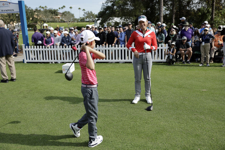 Annika Sorenstam, right, talks to her son Will McGee, left, on the first tee during the first round of the PNC Championship golf tournament Saturday, Dec. 17, 2022, in Orlando, Fla. (AP Photo/Kevin Kolczynski)