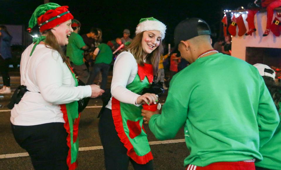 Fort Walton Beach Christmas Parade participants handed out trinkets to fans who lined Eglin Parkway on Monday night.