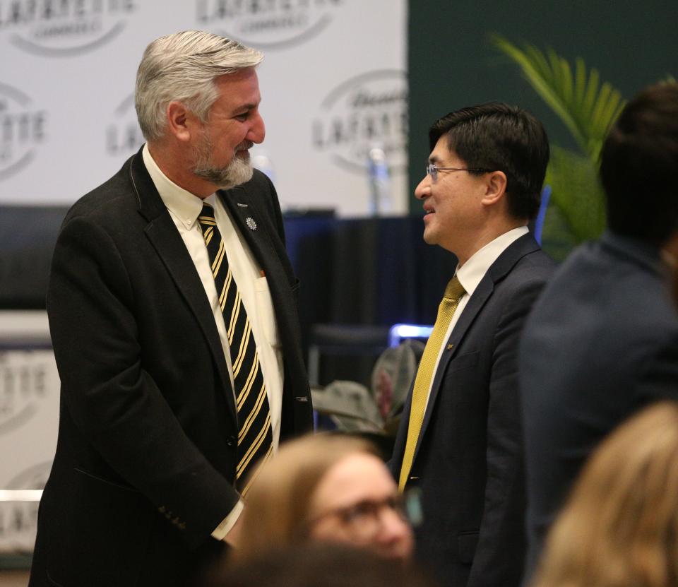 Indiana Gov. Eric Holcomb speaks with Purdue President Mung Chiang, at the Greater Lafayette Commerce annual luncheon, on Monday, Feb. 6, 2023, in Lafayette, Ind.