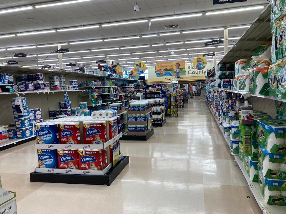 An aisle of paper products like towels and toilet paper at Kroger.