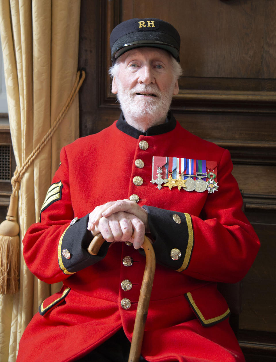 In this image taken on April 29, 2020 World War II veteran Bob Sullivan poses for a photo at the Royal Hospital Chelsea in London. Forgive British World War II veteran Bob Sullivan for being unfussed about VE-Day. After all, on May 8, 1945, he was lying in Cossham Hospital, having been wounded in the closing days of the fight to defeat the Nazis. As he couldn't move because of a plaster cast on his leg, he wasn't even able to attend a celebratory supper.(Liam Best via AP)