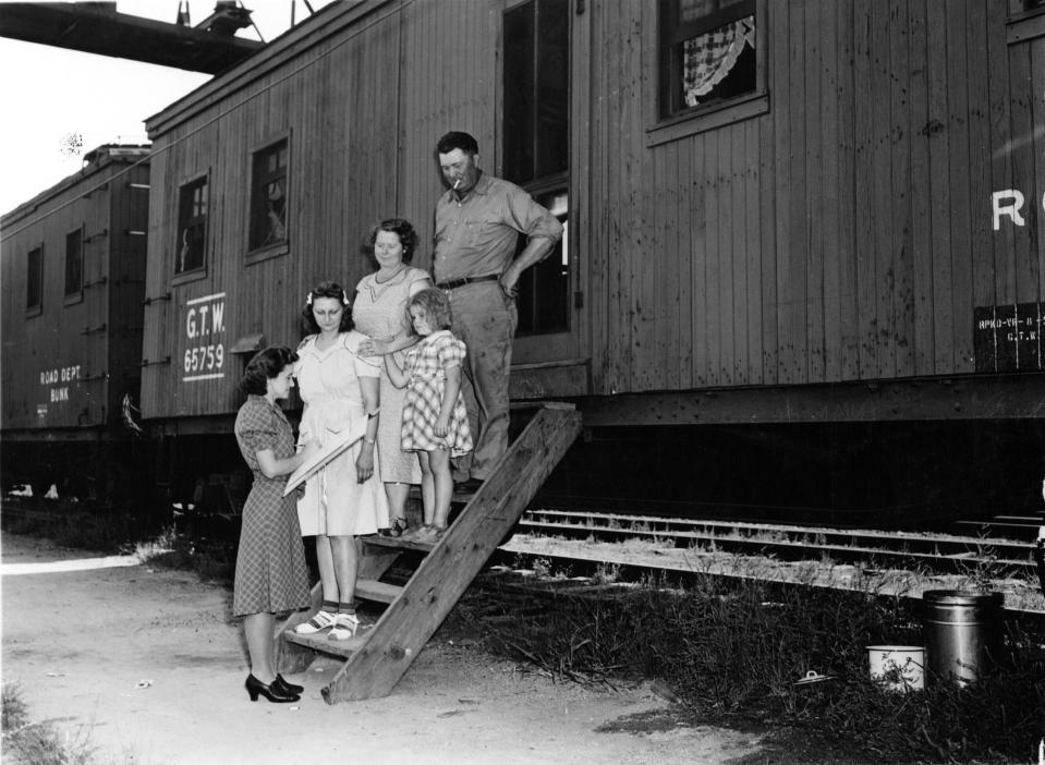 In this photo provided by the National Archives at College Park, an enumerator, left, interviews a family outside a rail car for the 1940 Census. Veiled in secrecy for 72 years because of privacy protections, the 1940 U.S. Census is the first historical federal decennial survey to be made available on the Internet initially rather than on microfilm. (AP Photo/National Archives at College Park)