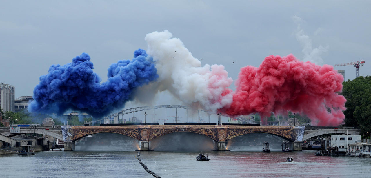 Paris 2024 Olympics - Opening Ceremony - Paris, France - July 26, 2024. Smoke clouds in the tricolours of the France flag are seen at Pont d'Austerlitz during the opening ceremony. (Photo by Ann Wang / POOL / AFP) (Photo by ANN WANG/POOL/AFP via Getty Images)