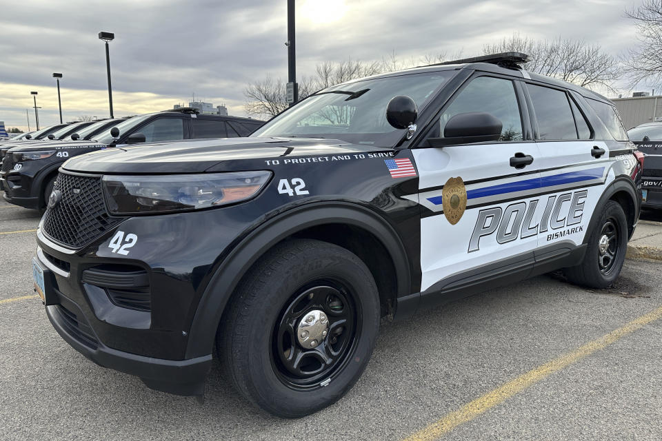 A Bismarck police vehicle sits outside the Bismarck Police Department in Bismarck, N.D., on Monday, Nov. 13, 2023. Seventeen-year-old Nicholas Bruington was fatally shot by police early Sunday, Nov. 12, during a traffic stop in a mall parking lot. Bruington was the lead suspect in a police investigation into a reported shooting. The three officers who shot at Bruington are on administrative leave after the shooting, which is being investigated by the North Dakota Bureau of Criminal Investigation. (AP Photo/Jack Dura)