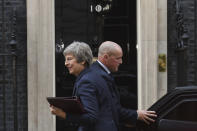 British Prime Minister Theresa May smiles outside 10 Downing Street, London, Wednesday, Nov. 14, 2018. British Prime Minister Theresa May is set to face her divided Cabinet in a bid to win support for a draft Brexit deal with the European Union. Negotiators from the two sides have reached agreement on divorce terms, including a plan to resolve the key issue of the Irish border. (Stefan Rousseau/PA via AP)