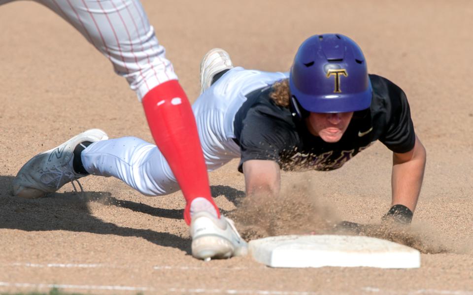 Tokay's Brock Sell dives back to first on a pickoff attempt during a varsity baseball game against Tokay at Lincoln in Stockton on Wednesday, Apr.19, 2023.