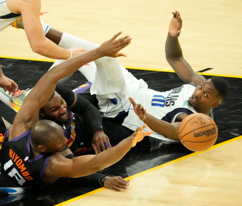 May 15, 2022; Phoenix, Ariz. U.S.; Phoenix Suns center Bismack Biyombo (18) and forward Jae Crowder (99) dive for the ball with Dallas Mavericks forward Dorian Finney-Smith (10) during game 7 of the Western Conference semifinals at Footprint Center.