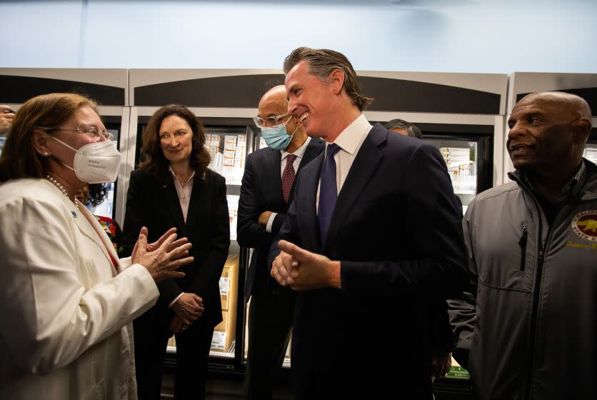 Downey, CA - March 18: Dr. Tanya Spirtos, M.D., president-elect of the California Medical Association, left, speaks briefly with Governor Gavin Newsom, right, following a press conference. California Governor Gavin Newsom just announced that the state has landed a contract with a company to produce insulin during a press conference at Kaiser Permanente Pharmacy on Saturday, March 18, 2023, in Downey, CA. His plan for a state-run insulin program is part of Newsom's broader agenda to reduce health care costs for Californians. (Francine Orr / Los Angeles Times)