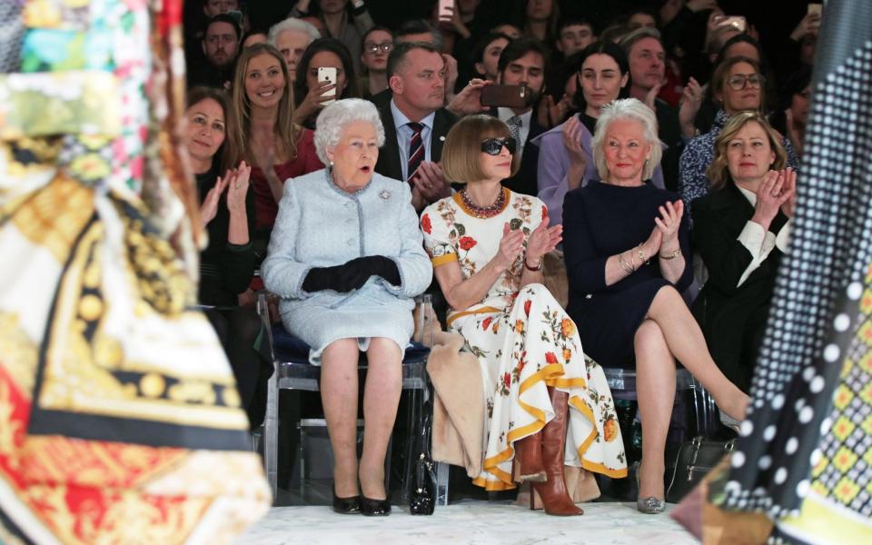 The late Queen with Anna Wintour, editor of US Vogue and Ms Kelly at a show for London Fashion Week in 2018 - Getty