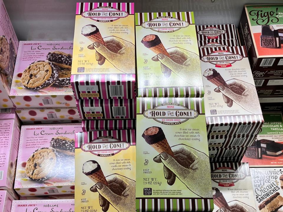 Pink, yellow, and green boxes with images of ice-cream treats on them in the freezer section at Trader Joe's