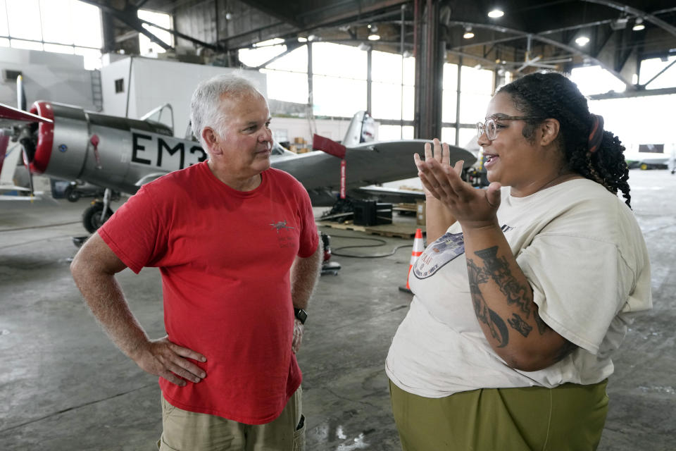 Wayne Lusardi, Michigan's state maritime archaeologist with the Department of Natural Resources, left, talks with Isis Gillespie, Tuskegee Airmen National Historical Museum's conservator of the P-39 at the museum, Thursday, Aug. 17, 2023 in Detroit. The plane was flown by a member of the famed Tuskegee airmen that crashed during training nearly 80 years ago near Port Huron, about 60 miles northeast of Detroit. (AP Photo/Carlos Osorio)