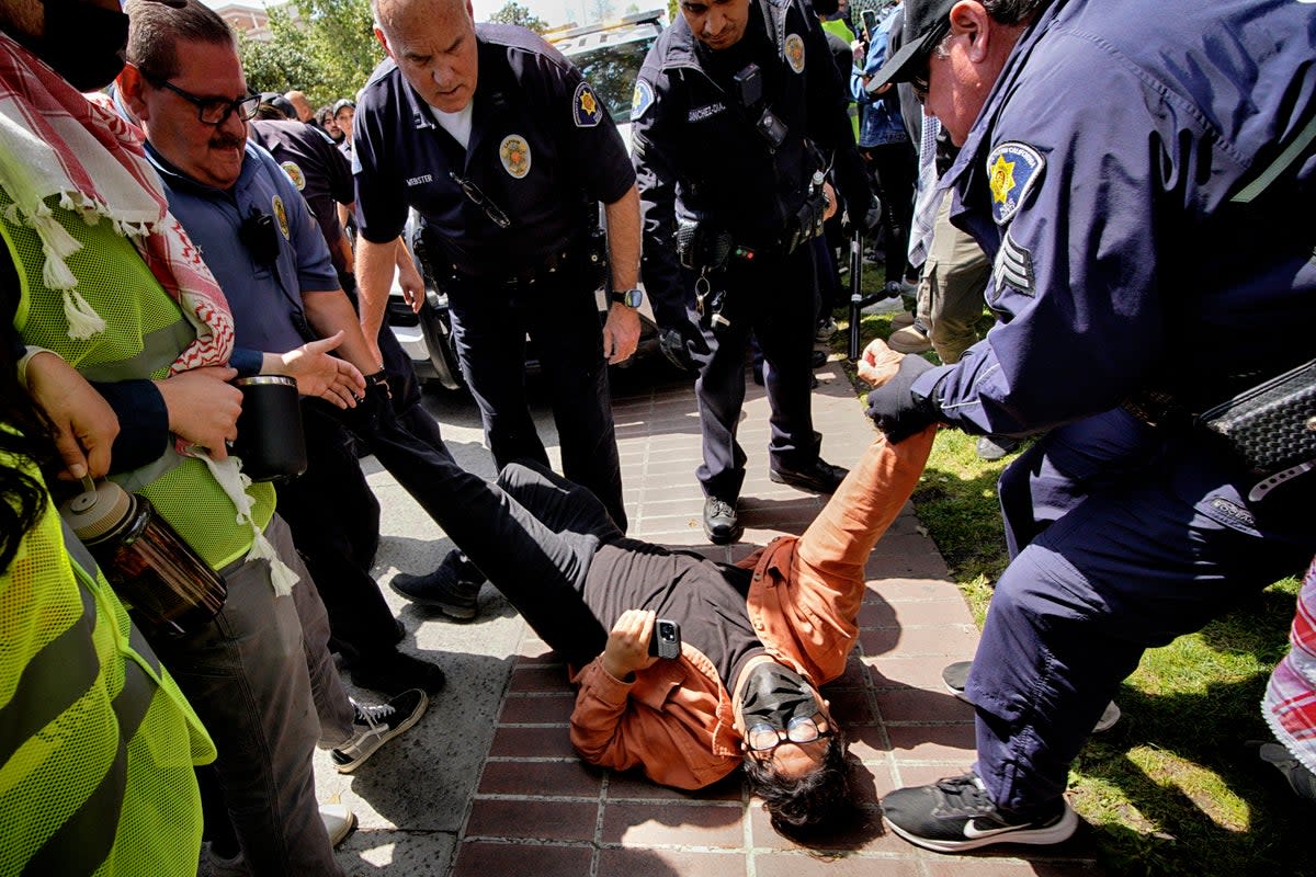 A protester at USC is detained by campus security following clashes at the university on Wednesday 24 April (Copyright 2024 The Associated Press. All rights reserved.)