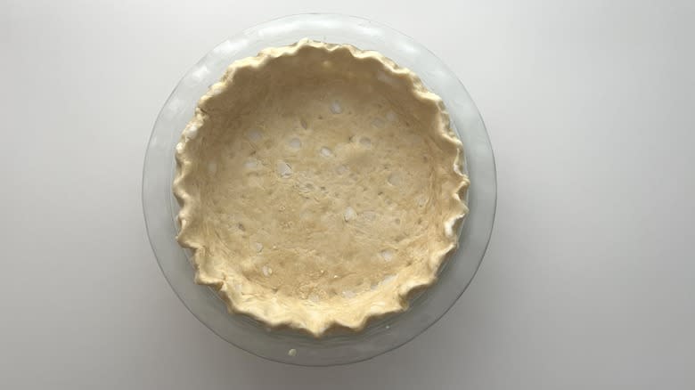 pie crust crimped around the edges in a pie plate