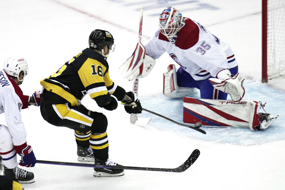 Pittsburgh Penguins' Jason Zucker (16) can't get a shot past Montreal Canadiens goaltender Sam Montembeault (35) with Mike Matheson (8) defending during the second period of an NHL hockey game in Pittsburgh, Tuesday, March 14, 2023. (AP Photo/Gene J. Puskar)