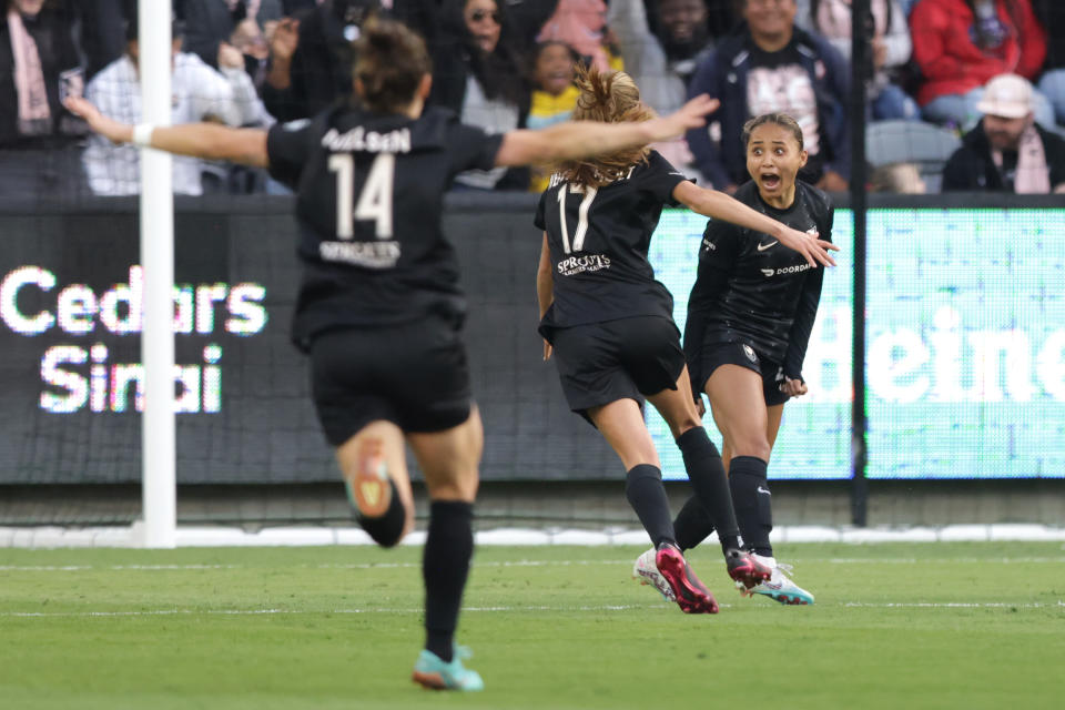 LOS ANGELES, CALIFORNIA - MARCH 26: Alyssa Thompson #21 of Angel City FC reacts with teammates Paige Nielsen #14 and Dani Weatherholt #17 after scoring a goal in the first half of a game against NJ/NY Gotham FC at BMO Stadium on March 26, 2023 in Los Angeles, California. (Photo by Katharine Lotze/Getty Images)