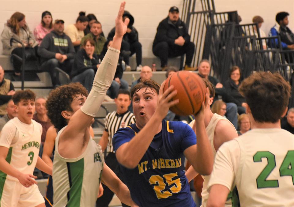 Mt. Markham Mustang Gio Barletta (25) prepares to shoot against Herkimer Magician Nick Caruso during the second half of Monday's game.