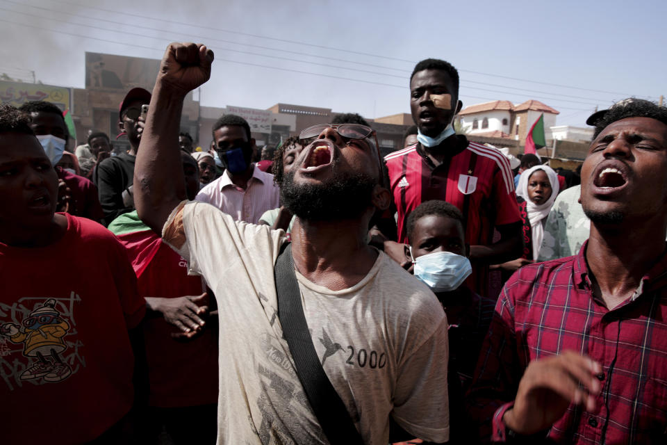 People chant slogans during a protest to denounce the October 2021 military coup, in Khartoum, Sudan, Thursday, Jan. 6, 2022. Sudanese took to the streets in the capital, Khartoum, and other cities on Thursday in anti-coup protests as the country plunged further into turmoil following the resignation of the prime minister earlier this week. (AP Photo/Marwan Ali)