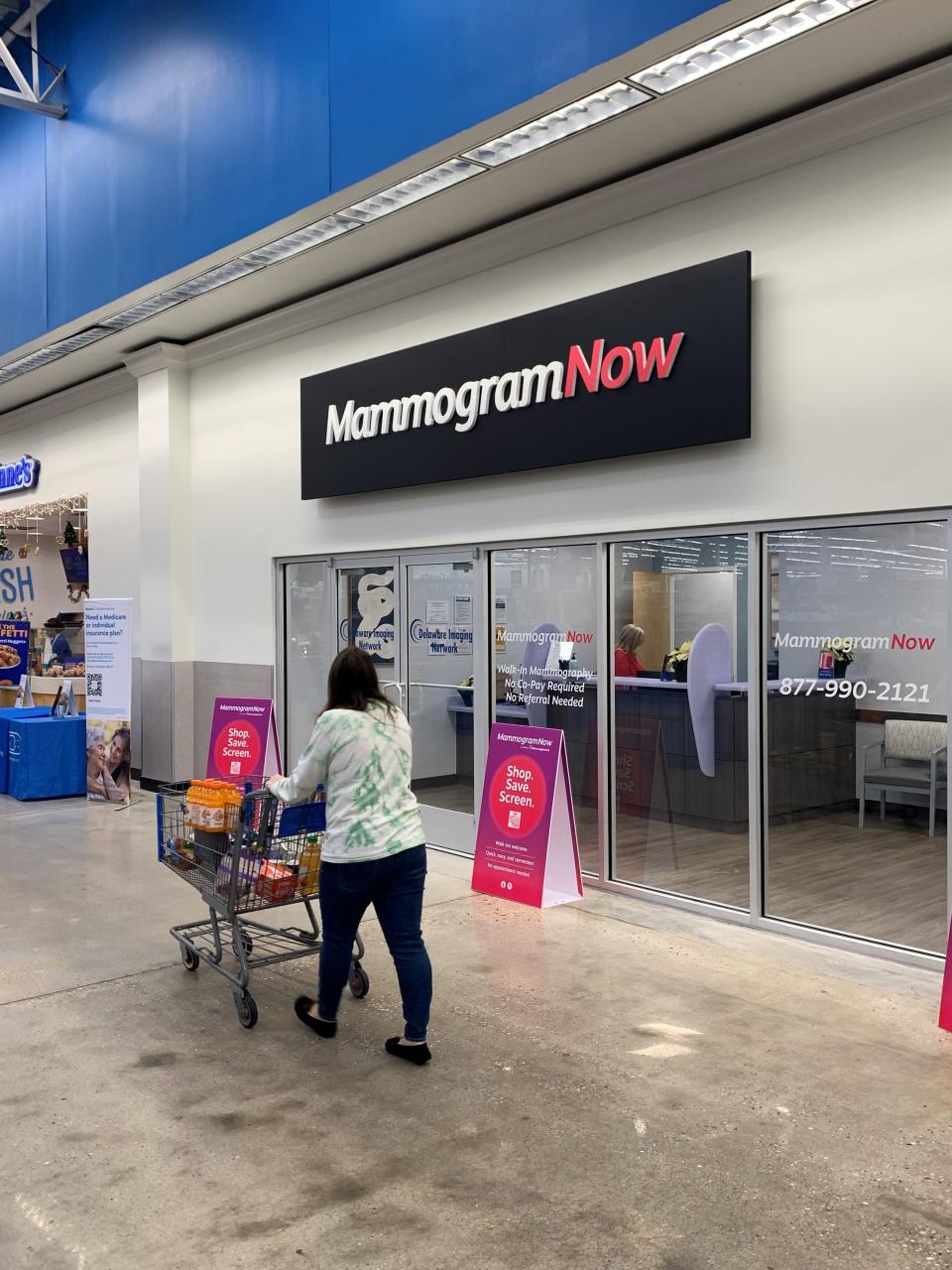 A customer walks past a MammogramNow located inside the Walmart Supercenter in Milford. The retailer is a pilot site for the diagnostic imaging company's plans to offer mammography screenings. It opened Dec. 8, 2023.