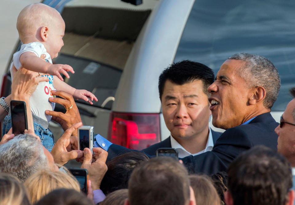 <p>While greeting well wishers after arriving at John F. Kennedy International Airport in New York, President Barack Obama reaches out to Desmond Hatfield-Rudin, eight months old, of the Brooklyn borough of New York, Sunday, Sept. 18, 2016, in New York. (AP Photo/Craig Ruttle) </p>