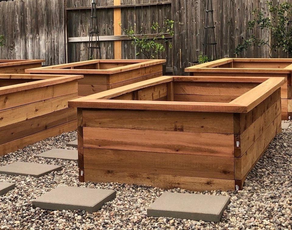 cedar raised beds surrounded by stepstones and pea gravel