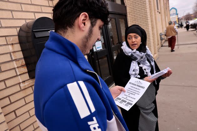 Samra'a Luqman, right, hands out fliers outside a Dearborn Heights mosque on Feb. 16, urging worshipers to vote 