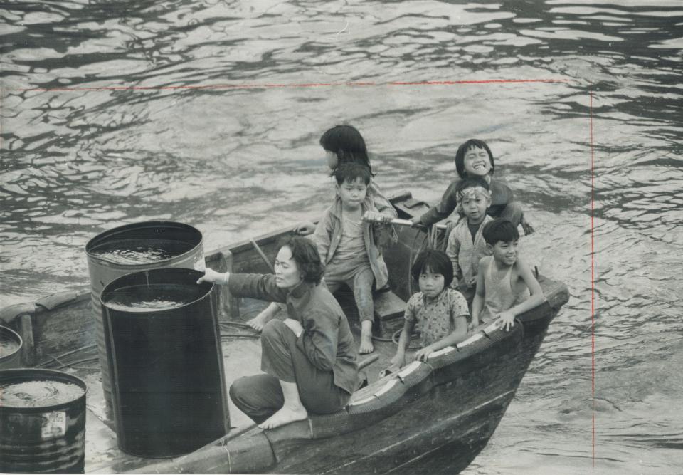 A family living on a small boat in Aberdeen Harbor.