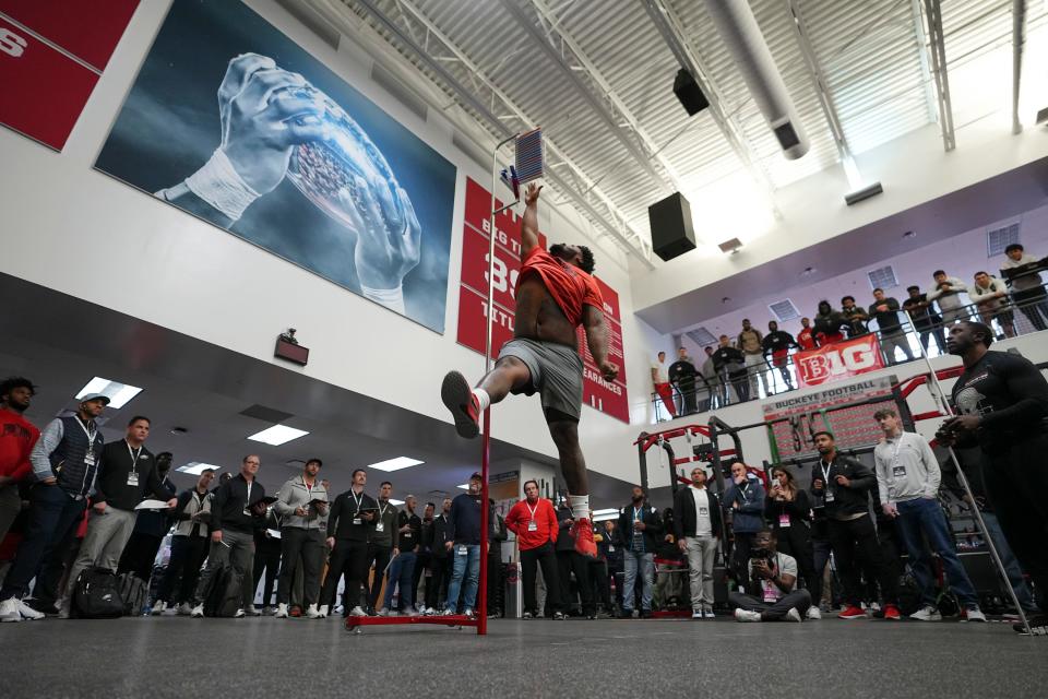 Ohio State Buckeyes defensive tackle Jerron Cage leaps to measure his reach during Ohio State football’s pro day at the Woody Hayes Athletic Center in Columbus on March 22, 2023. 