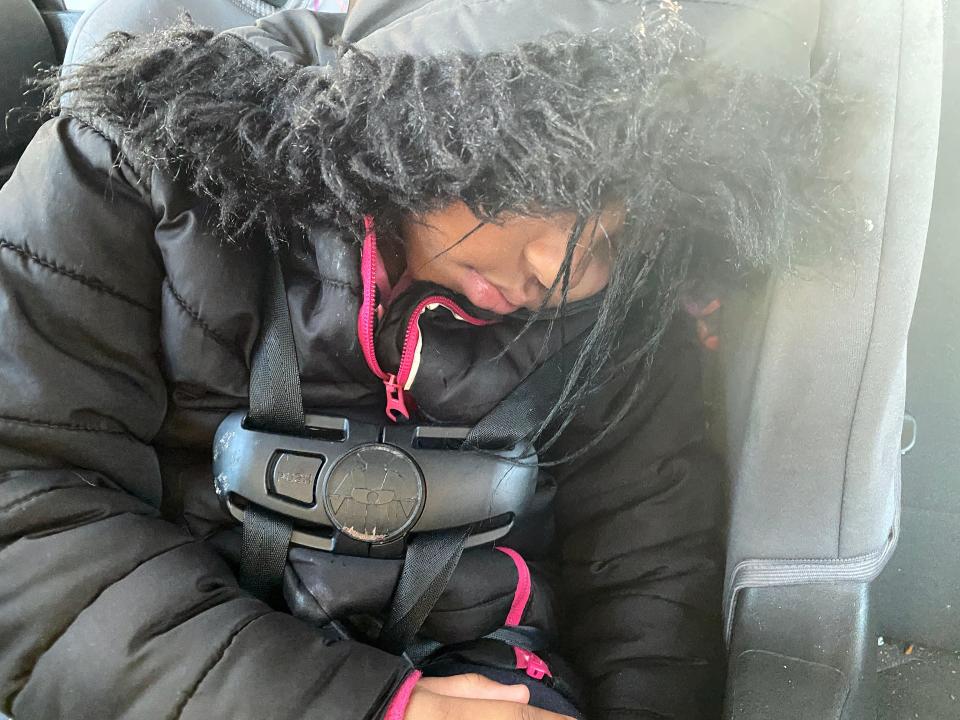 Layoni Haskins, 3, is sound asleep in the back of her mom’s car after the hour-and-a-half round trip to drop her older sister off at school in Grand Rapids, Michigan, where they live.