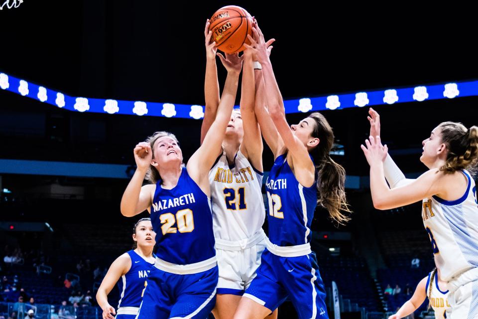 Iris Schilderink (20), Journie Hillard (21), and Emma Kleman (12), all fight for the rebound during the 1A state final between Nazareth and Dodd City at the Alamodome in San Antonio Wednesday. Dodd City went on to win the contest 30-21. [Matt Smith/for the Amarillo Globe-News]